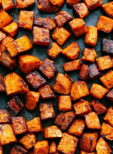 Bowl of colorful roasted vegetables, showcasing vibrant peppers, carrots, and zucchini.