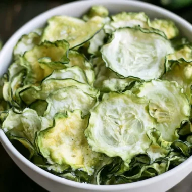 Salt and vinegar cucumber chips in a bowl, a healthy snack option.