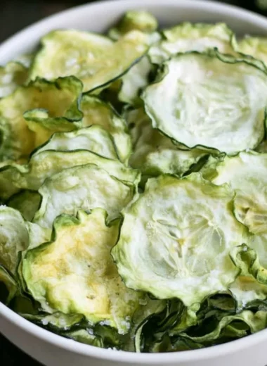 Salt and vinegar cucumber chips in a bowl, a healthy snack option.