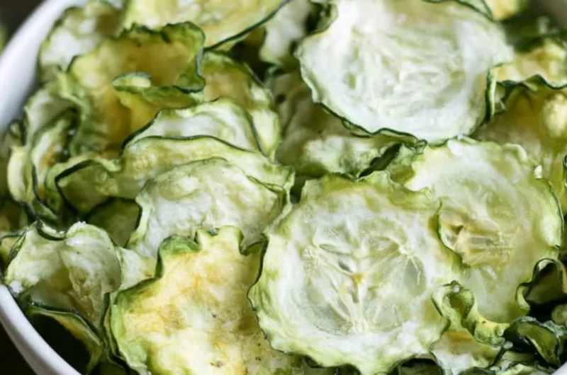 Salt and vinegar cucumber chips in a bowl, a healthy snack option.