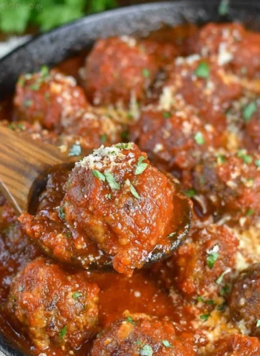 Deliciously cooked Italian meatballs served with pasta and sauce.