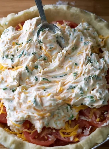 Homemade Tomato Pie served on a plate with fresh herbs and cheese