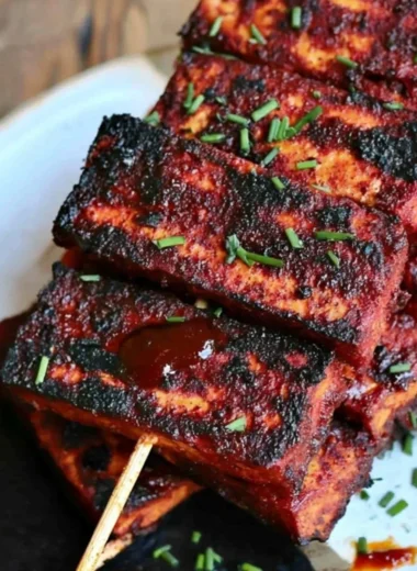 Vegan Sweet and Spicy BBQ Tofu served on a plate with colorful vegetables