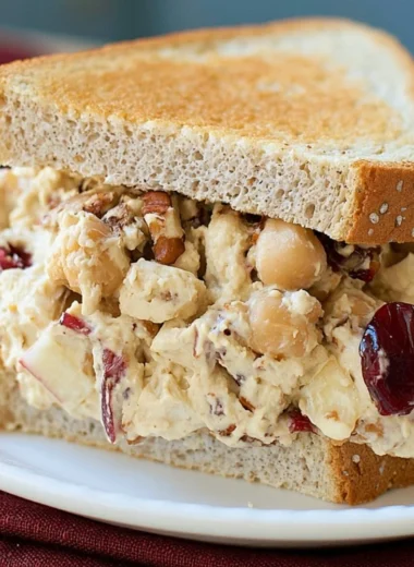 A vibrant Apple Pecan Chickpea Salad Sandwich on whole grain bread