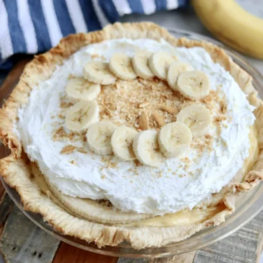 Slice of delicious Banana Cream Pie with whipped cream and fresh bananas