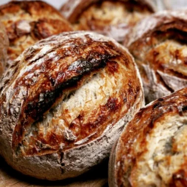 Beginner's sourdough bread recipe showing the process from starter to baked loaf.