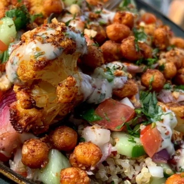 Cozy Cauliflower Shawarma Bowl garnished with fresh vegetables and sauce