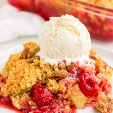 Cozy cherry dump cake topped with a golden crumble and fresh cherries