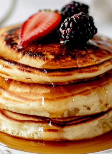 Cozy fluffy pancakes served on a plate, perfect for a solo breakfast