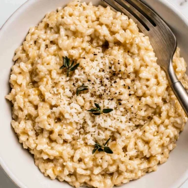 Creamy easy risotto served in a bowl with fresh herbs.