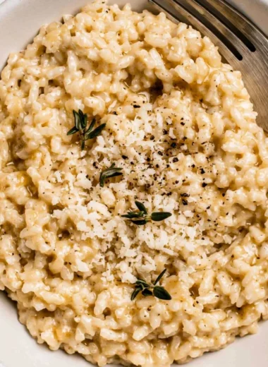 Creamy easy risotto served in a bowl with fresh herbs.