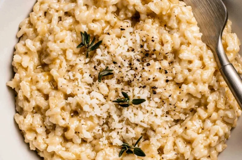 Creamy easy risotto served in a bowl with fresh herbs.