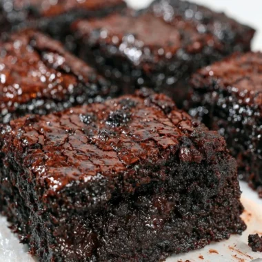 Delicious easy sourdough brownies on a plate, topped with chocolate glaze.