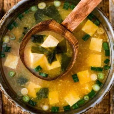 Bowl of homemade miso soup with tofu garnished with green onions