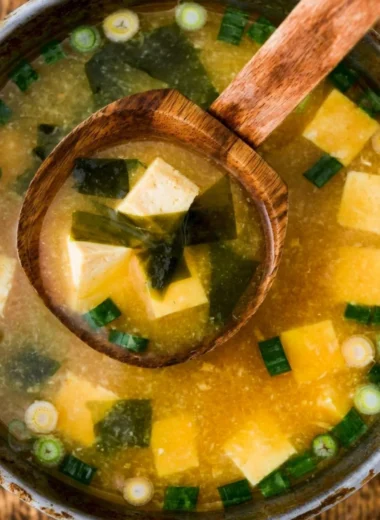 Bowl of homemade miso soup with tofu garnished with green onions