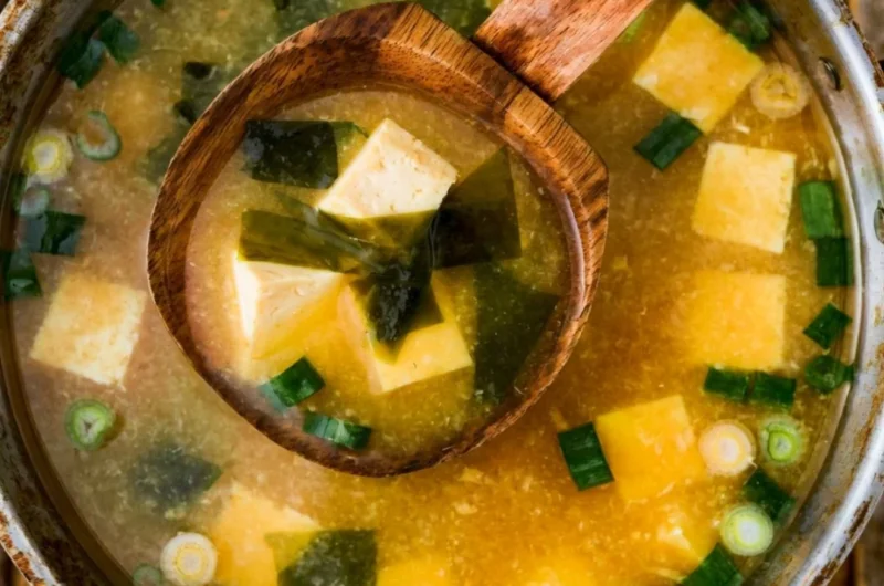 Bowl of homemade miso soup with tofu garnished with green onions