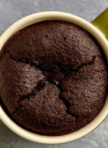 Decadent lava cake served with chocolate sauce and fresh berries.