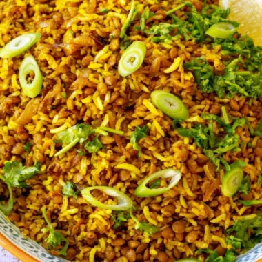 Bowl of Mediterranean Lentils and Rice garnished with herbs and spices.