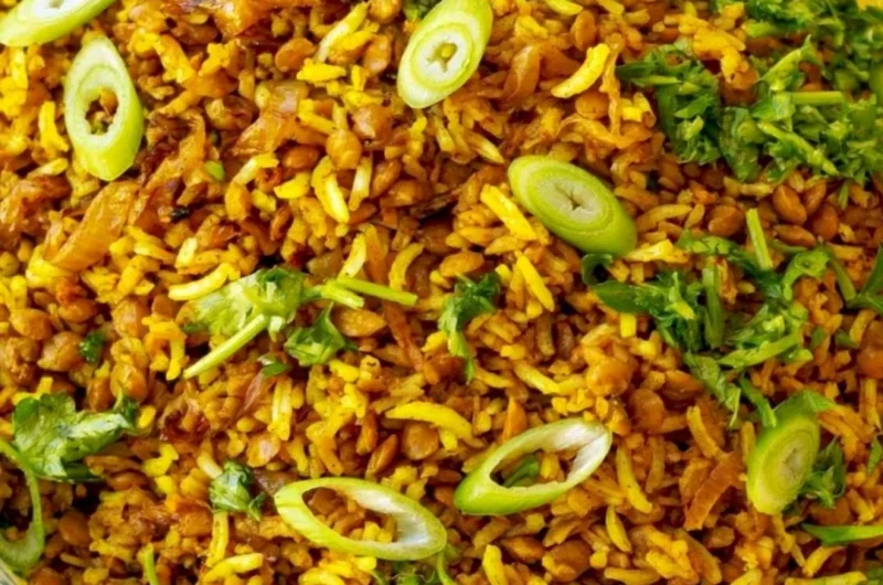 Bowl of Mediterranean Lentils and Rice garnished with herbs and spices.