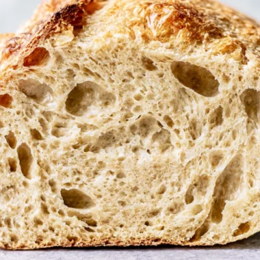 Freshly baked sourdough bread with a golden crust and airy crumb.