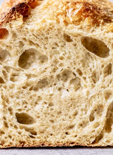 Freshly baked sourdough bread with a golden crust and airy crumb.