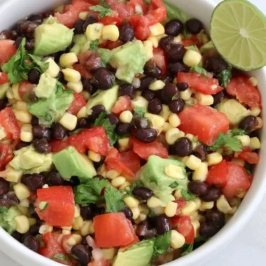 Colorful bean salad prepared for meal prep with fresh vegetables.