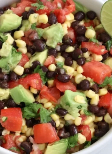Colorful bean salad prepared for meal prep with fresh vegetables.