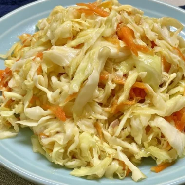 Vinegar and oil coleslaw served in a bowl, showcasing fresh vegetables and dressing