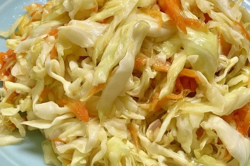 Vinegar and oil coleslaw served in a bowl, showcasing fresh vegetables and dressing