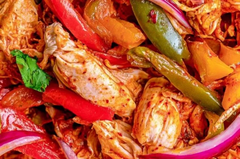 Savory crockpot chicken fajitas served in a bowl with colorful vegetables.