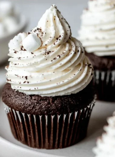 Hot chocolate cupcakes with marshmallow buttercream frosting on a plate