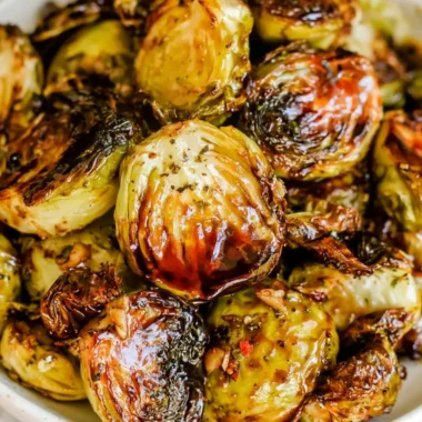 Plate of roasted Brussels sprouts drizzled with honey balsamic sauce