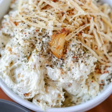 Creamy roasted garlic dip served with fresh vegetables and toasted bread