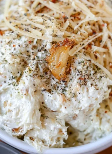 Creamy roasted garlic dip served with fresh vegetables and toasted bread