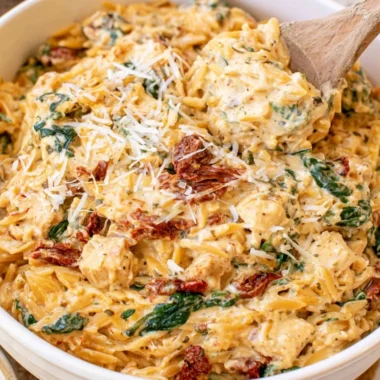 Delicious Slow Cooker Creamy Tuscan Chicken Orzo served in a bowl